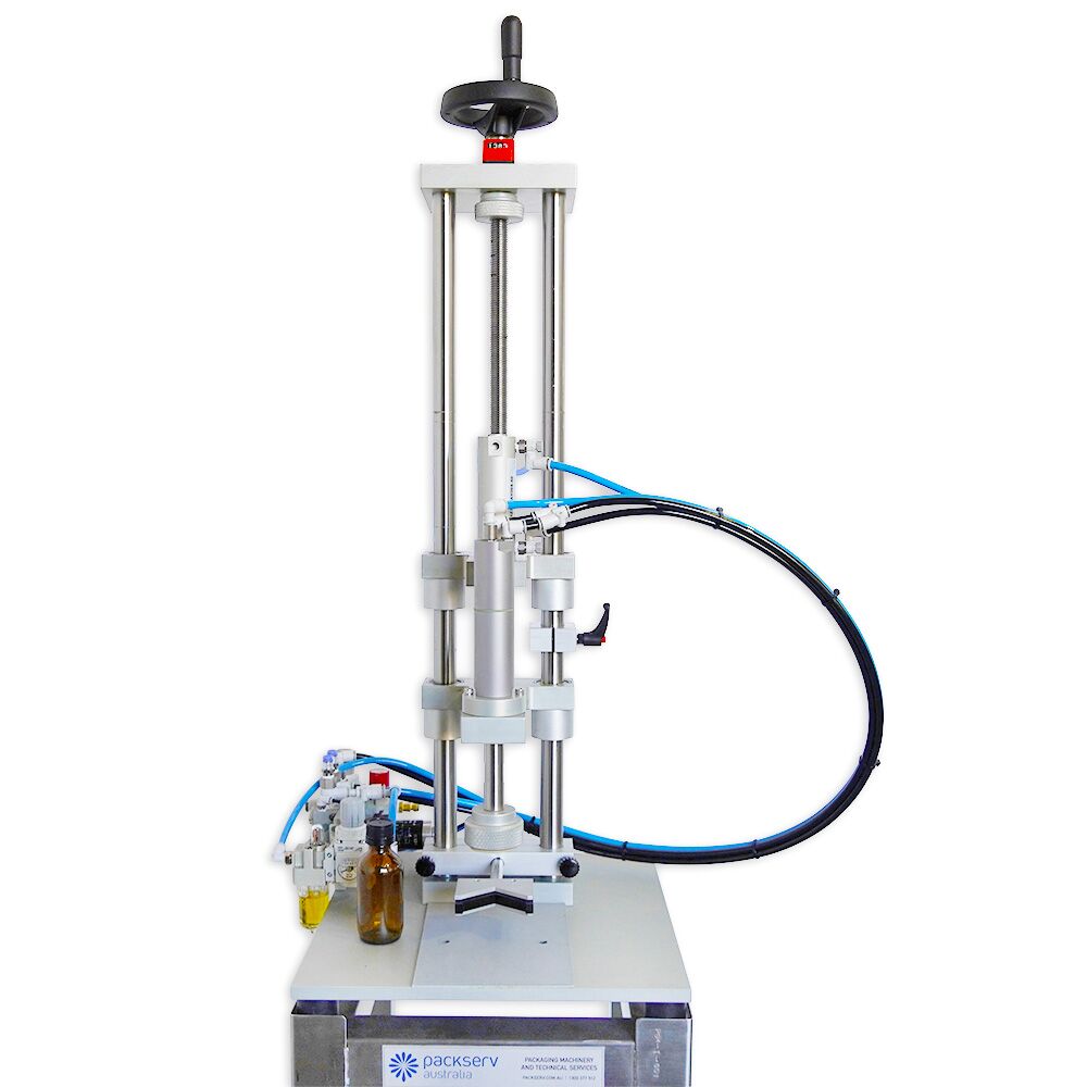 Packserv PCM-1 Bench Model Capper positioned above a stainless steel trolley for mobile operation