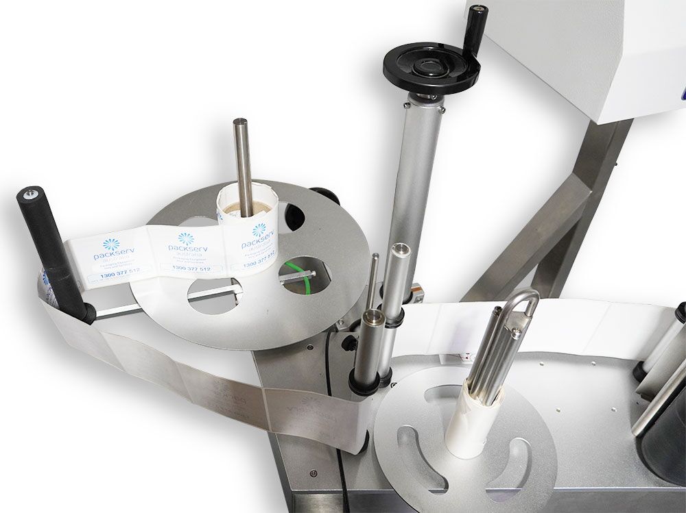 Close-up of label application area on the PL-10 Pack Leader Top Wipe-On Labeller showing wipe-on pad and conveyor